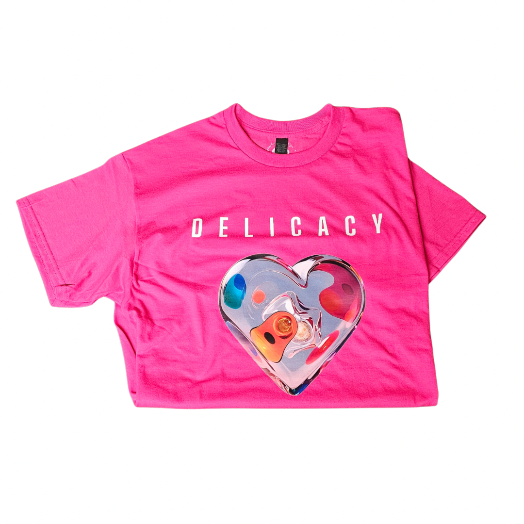 The Try My Closet Delicacy Heart Color Purple Changing Graphic Tee features DELICACY in white above a vibrant, color-changing abstract heart on the front for a playful, standout style.