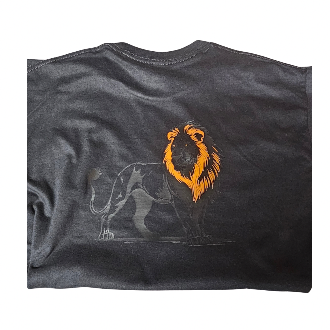 The Protective Graphic Tee by Try My Closet features a dark gray design with a black lion and bold, bright orange mane graphic on the back. Custom orders are welcome for this unique shirt.