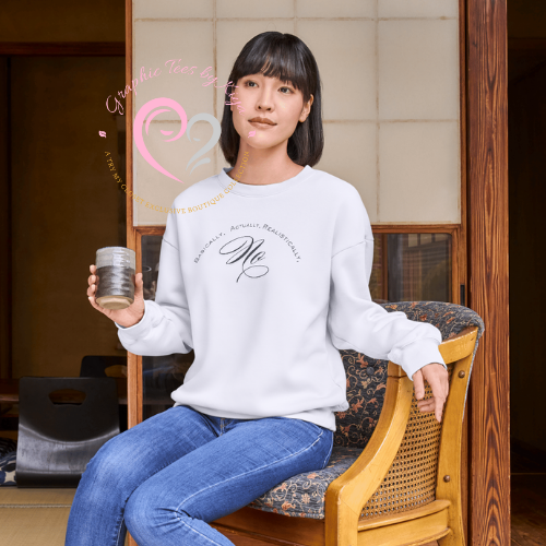 A woman with straight dark hair wears the Passive Boundaries Graphic Tee from Try My Closet and blue jeans as she sits on a patterned chair in a traditional room, holding a glass cup and gazing to the side with minimalist style.