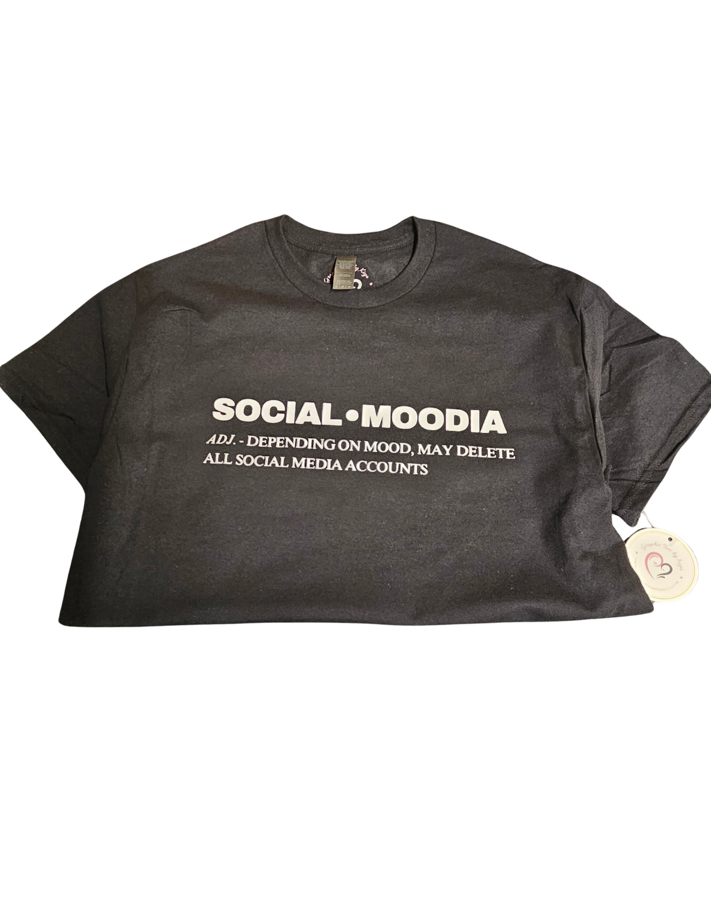 The Try My Closet Social Moodia Graphic Tee is a black shirt with “SOCIAL-MOODIA adj.: Depending on mood, may delete all social media accounts” in white. Custom orders are available for a personal touch.