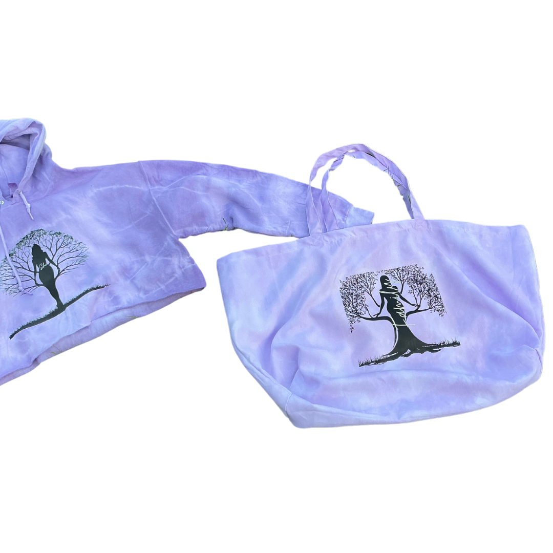 The She’s Rooted in Family Cropped Hoodie Oversized Tote Tie-Dye Set in purple (Large) by Try My Closet features a black silhouette of a woman and outstretched branches, symbolizing her deep family roots.