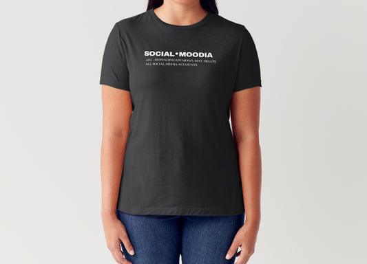 A woman wears the black Social Moodia Graphic Tee by Try My Closet with blue jeans. The shirt says: SOCIAL MOODIA—All depending on mood, may delete all social media accounts. Custom orders available.