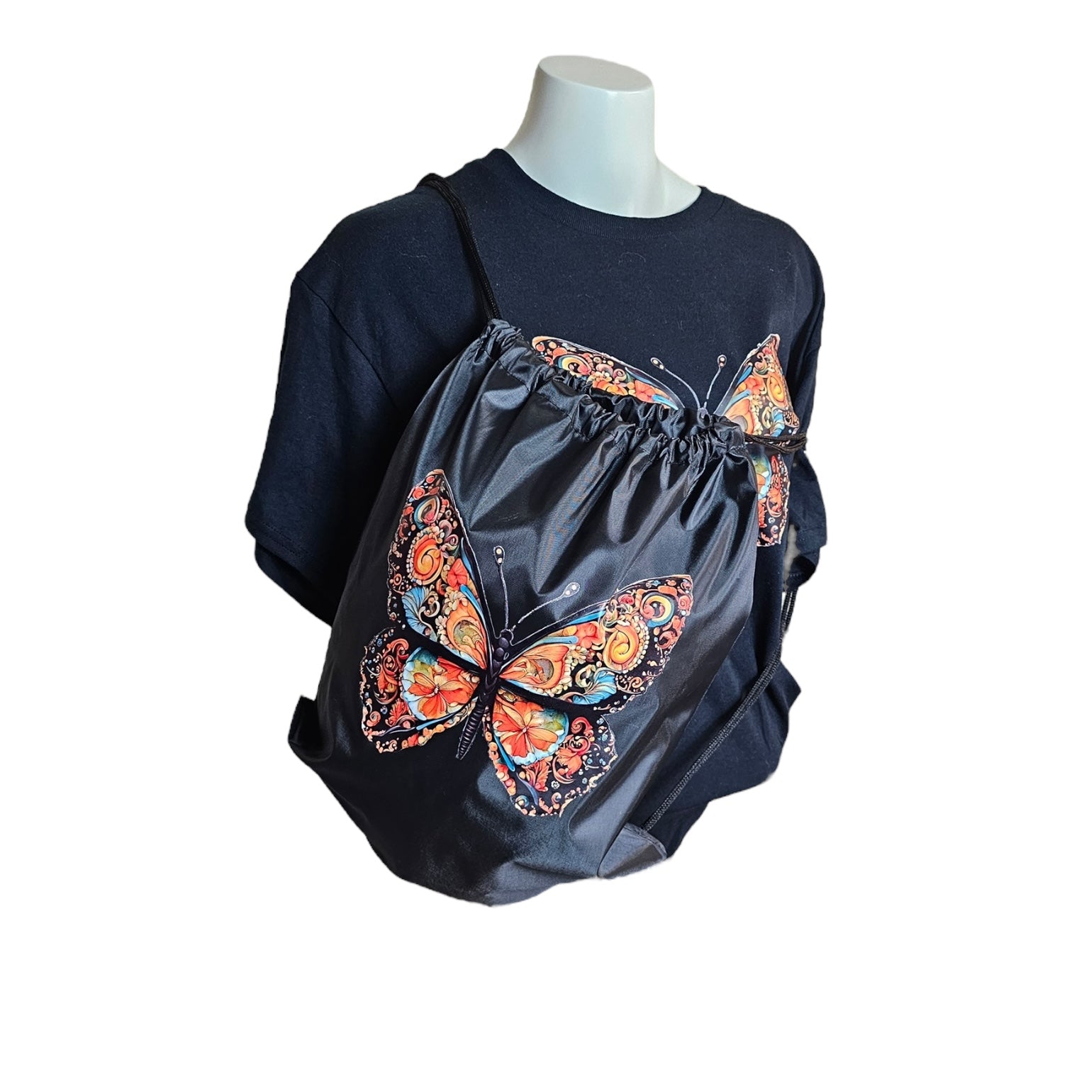 The Morphed Black Graphic Tee With Lightweight Drawstring Backpack Value Set by Try My Closet features bold, colorful butterfly designs on both items, shown on a white mannequin bust against a plain white background.