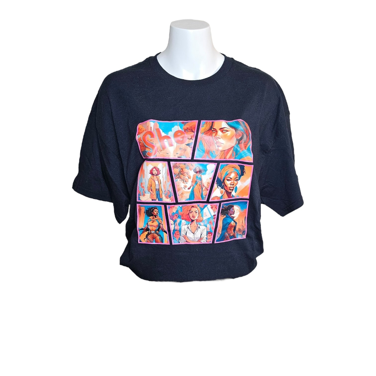 The She Comic Graphic Tee Limited Edition by Try My Closet is a black tee with a colorful, comic-style rectangular graphic of diverse illustrated women, shown on a white mannequin.