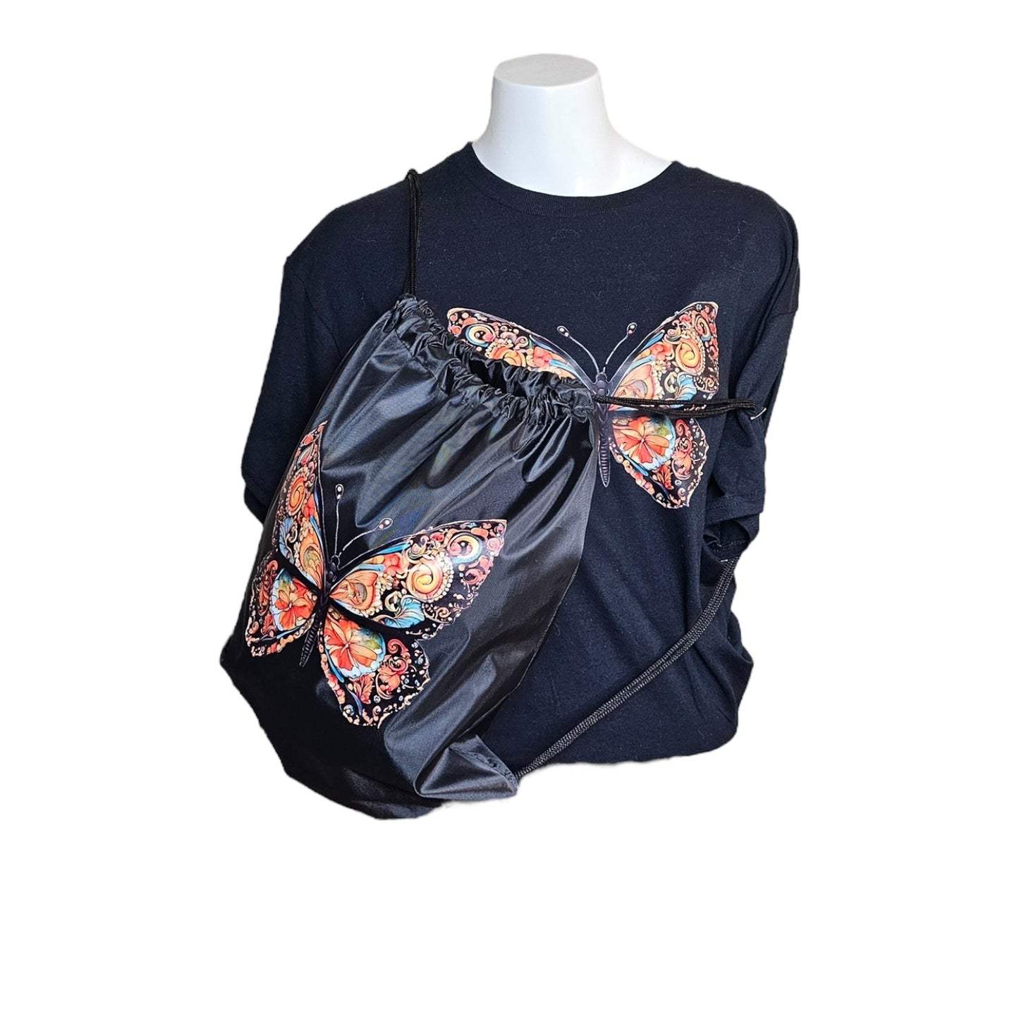 A black mannequin showcases the Try My Closet Morphed Black Graphic Tee and Lightweight Drawstring Backpack Value Set, both featuring a vibrant butterfly design—an eye-catching duo for standout style.