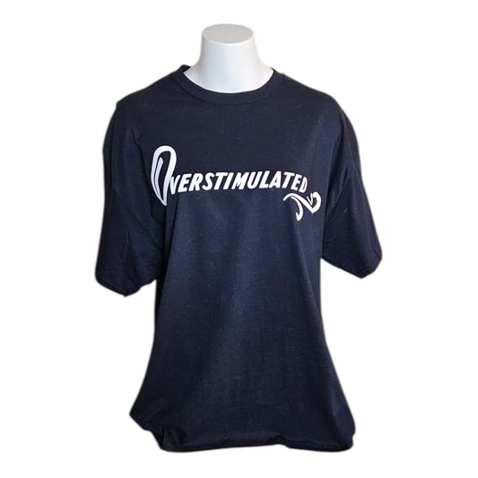 The Try My Closet Overstimulated Black Graphic Tee is shown on a white mannequin, featuring bold white OVERSTIMULATED lettering with a retro swirl design for standout graphic tee style.