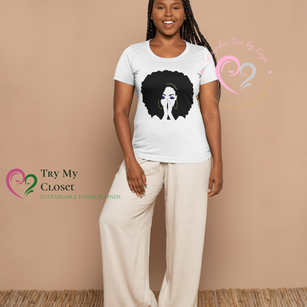 A smiling woman with long braids wears a white Current Mood Graphic Tee from Try My Closet featuring a woman with an afro and beige wide-leg pants. Logos for Try My Closet and Graphic Tees by Katja appear. Custom orders available.