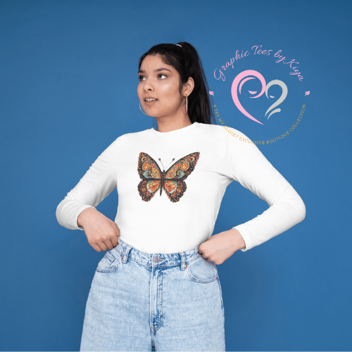 A woman in a white Morphed Graphic Tee by Try My Closet, featuring a colorful butterfly design, poses confidently against a blue background with light blue jeans. The Try My Closet logo is displayed beside her.